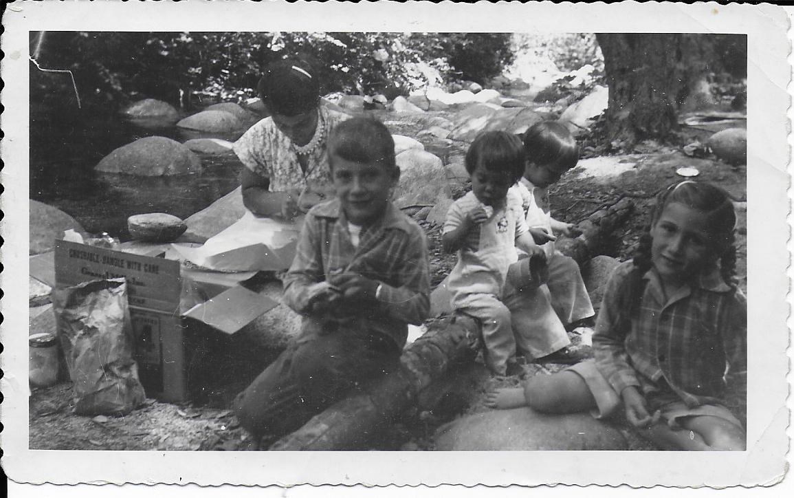 Black and white 1951 photo of Do-Be Peltier and four of her children on the boulder-strewn banks of Paige Boulder Creek. Photo courtesy of Sally Peltier Harvey.