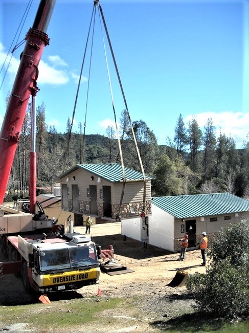 Oak Bottom Shower House being lifted into place by a large crane in 2015.