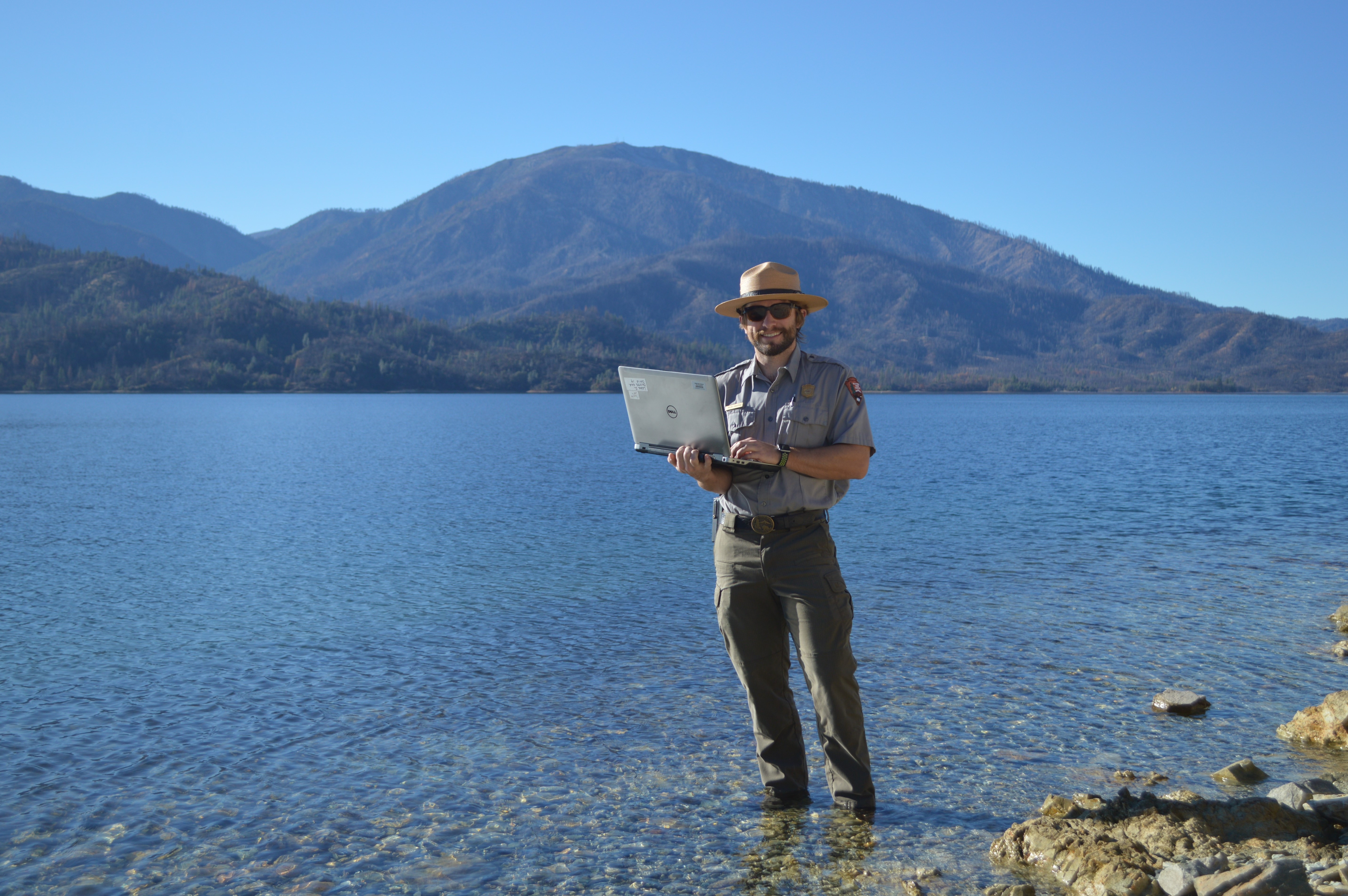 With laptop in hand, Tyler Compton, a Whiskeytown education ranger, awaits your virtual field trip!