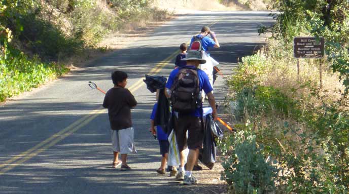 A family picking up litter to keep their park clean.