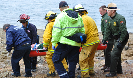 National park rangers rescuing injured visitor.