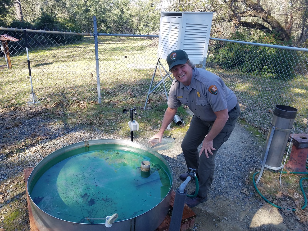 A Whiskeytown NRA natural resource manager making recordings at the park's official weather station.