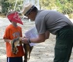A young child explores nature during the Junior Ranger Program