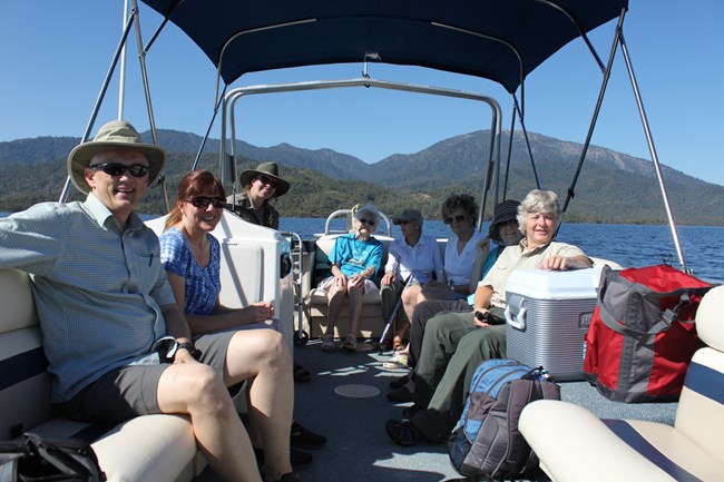 Senior citizens from a local assisted living facility enjoy a morning cruise on the lake with a ranger on a Patio Boat Tour