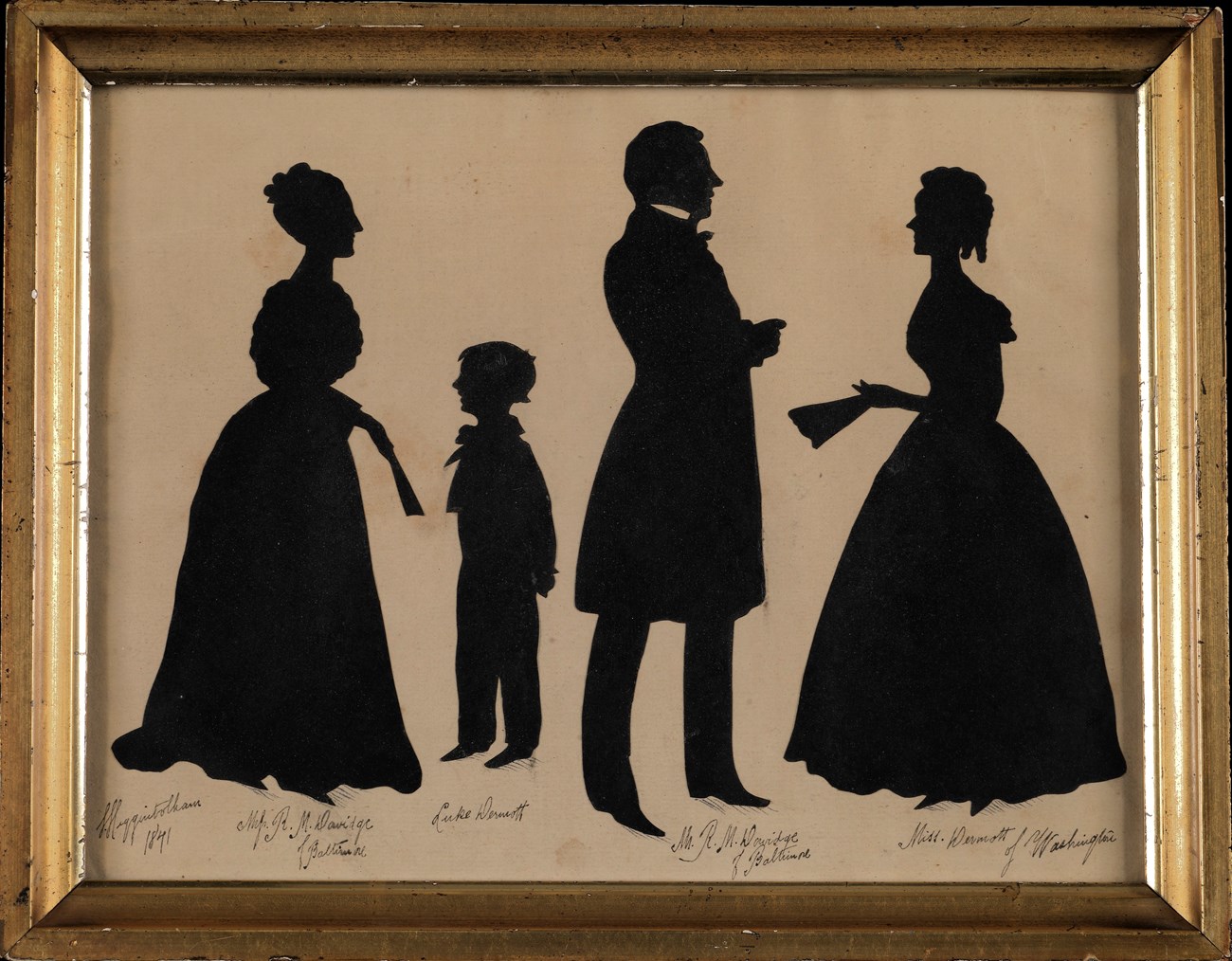Silhouette of a family four paper silhouettes of a family including a woman with her hair up in a floor length dress, a young boy, a man in a suit with a knee length jacket, and another woman with her hair up and curled in a floor length dress