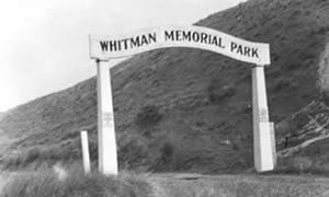 White wooden arch with the words, "Whitman Memorial Park." White wooden arch with the words, "Whitman Memorial Park."