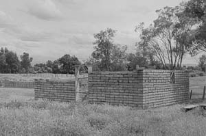The beginning of an adobe building. Walls about 4 feet high, no roof.