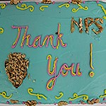 Frosting on a cake says “Thank you! NPS”