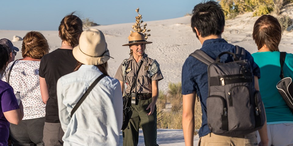 A ranger talks to a group of people