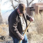 A volunteer holds a rake