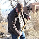 A volunteer holds a rake