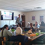 A staff member provides a presentation to a group