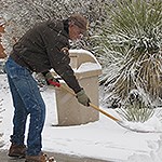 A volunteer holds a shovel