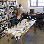 A volunteer works in a library