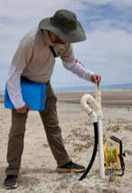 A volunteer checks survey equipment