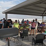 many people gathered under a shade structure
