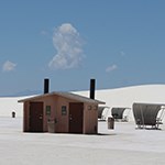 A restroom building among picnic tables