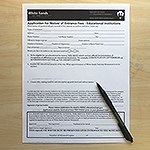 A form with boxes to check and a pen