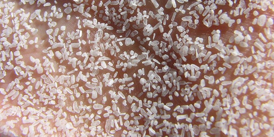 Sand grains on human palm Sand grains on human palm