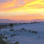 Dunes with a sunset on the background.