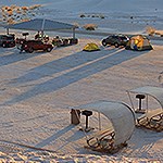 Picnic tables and a picnic shelter on sand