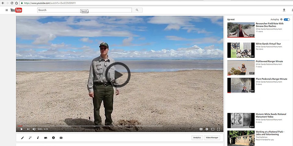 A video featuring a ranger standing in front of a lake under a cloudy sky