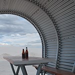Two bottles on picnic table under shelter