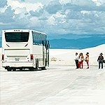 Visitors lining up to enter a bus out on the dunefield.