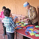 Volunteer with two young visitors.