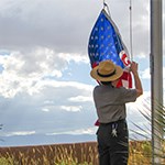 Park Ranger taking down American flag.