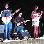 Three artists performing on the dunes