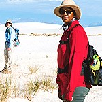 Two visitors hiking in the dunefield with proper hiking equipment.