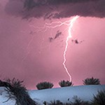 Lighting bolt striking white sand