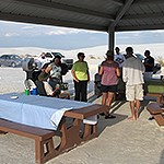 Small group gathered around picnic tables