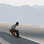 A young man slides down a down on a disc