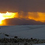 Rain in the dunefield with the San Andres Mountains in the background.