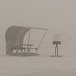 Windstorm in the dunefield with two picnic tables and a grill barely visible by the dust.