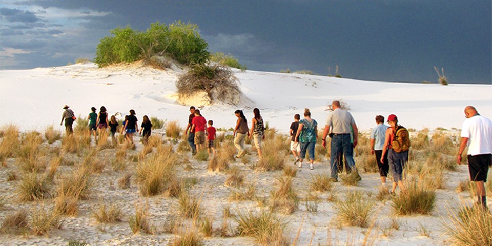 Visitors hiking through the interdunal area of the Sunset Stroll