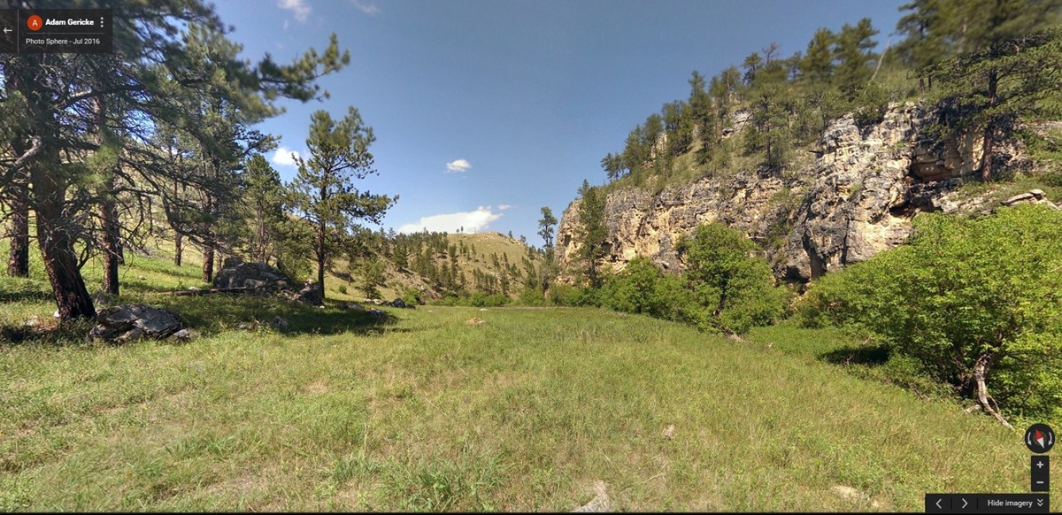 prairie meadow surrounded by limestone cliffs prairie meadow surrounded by limestone cliffs