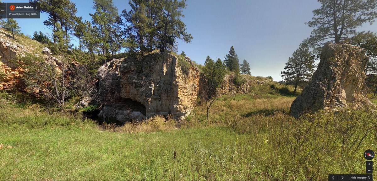 A watering hole next to a limestone cliff A watering hole next to a limestone cliff