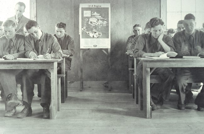 Photograph of CCC men in a classroom studying.