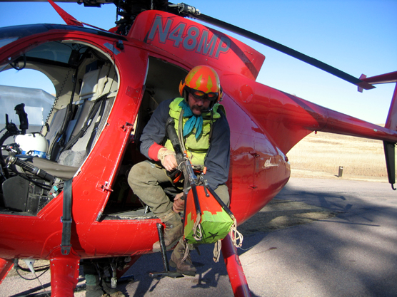 Leading Edge Aviation employee Wes Livingston inspects a net gun used to capture elk in Wind Cave National Park.