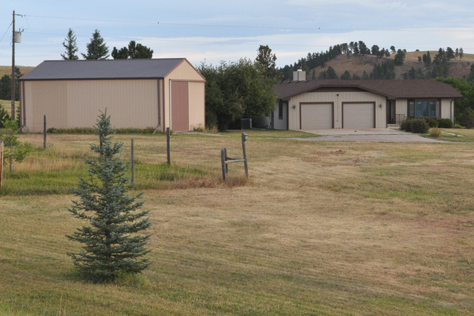 Photo showing house and pole barn recently acquired by the park.