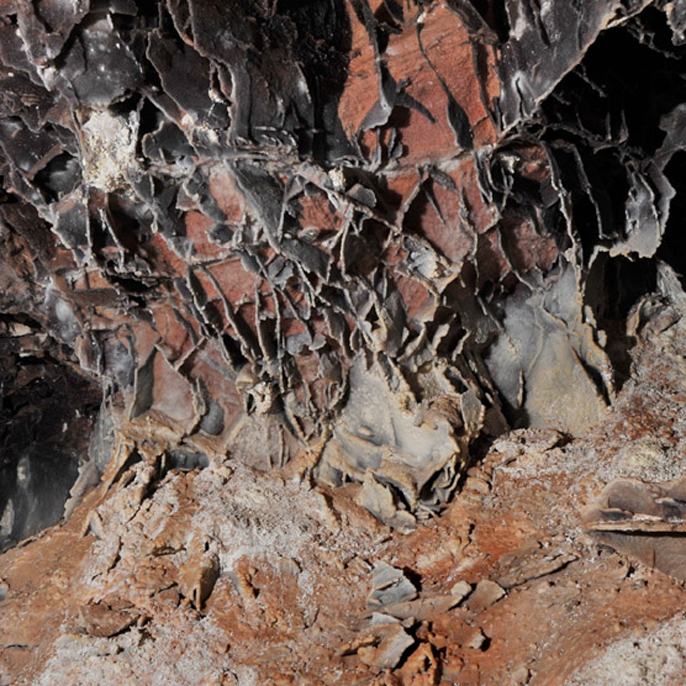 A photo of boxwork, a reddish/brown honeycomb looking formation.