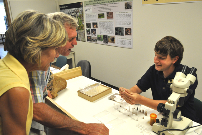 Visitors Steve and Jeannie Allgeier from Kentucky listen to Derek Jurestovsky talk about micro fossils found in Persistence Cave.