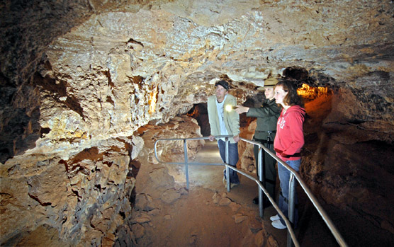 Ranger pointing out boxwork to cave visitors.