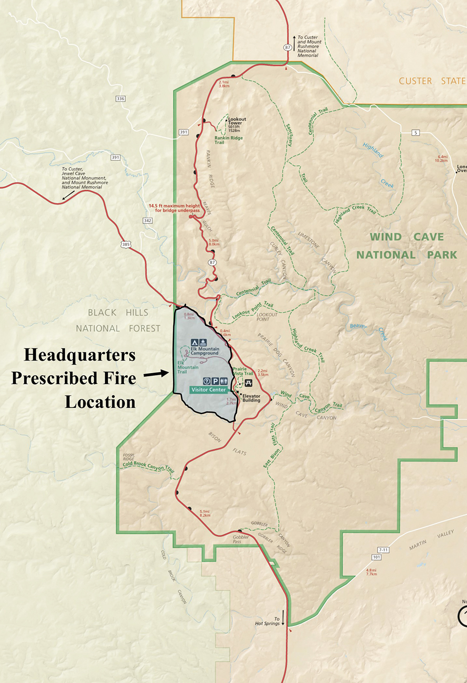 Map of western half of Wind Cave National Park. Park land is a light brown with roads in red. Land outside the park is a light green. In blue is the area inside the park scheduled to be burned.