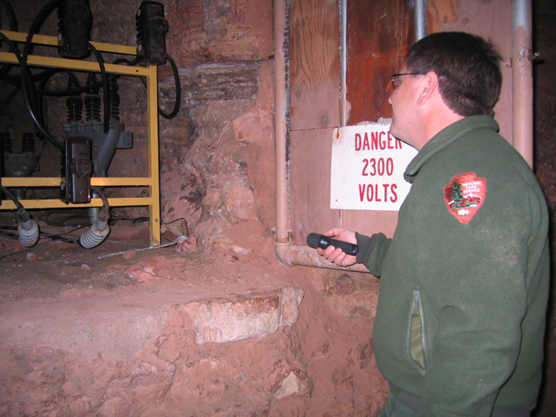 Facility Manager Steve Schrempp examines Wind Cave's current electrical system.