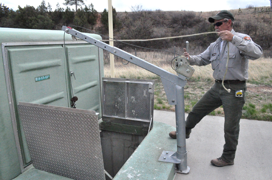 Jeff Simmons standing next to a hatch that opens below him to the lift station.