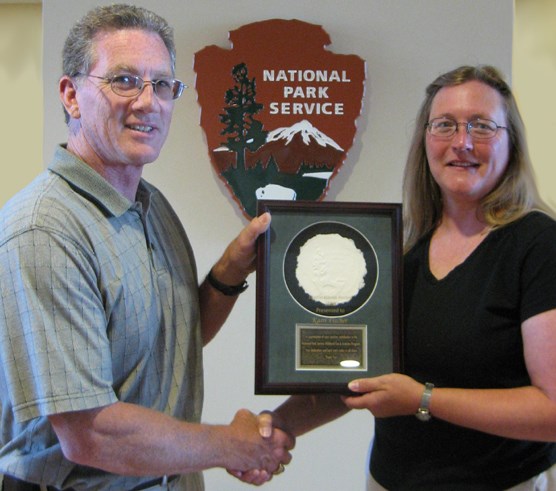 NPS Fire Director Mike Wallace presents Jeanie Harris Award to Wind Cave Fire Program Management Assistant Karri Fischer.